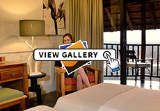 bedroom and deck of Lodge rooms at Victoria Falls Safari Lodge