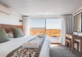 Suite with bed and view of river