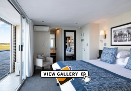 Standard Suite with bed and view of river