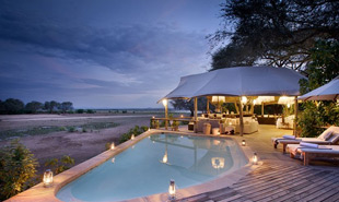 Swimming pool on the main deck with the Zambezi river in the background
