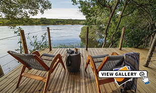 Deck chairs on the deck with river in the back ground