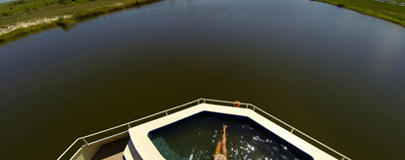 Circular plunge pool with guest. River in background