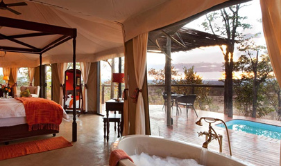 Bedroom with view of deck and private pool