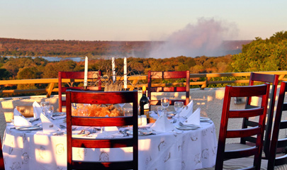 Table on the deck of the Rainbow Hotel, Spray from the falls in the background.