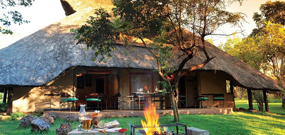 BBQ fire in foreground with one of the lodges in the background