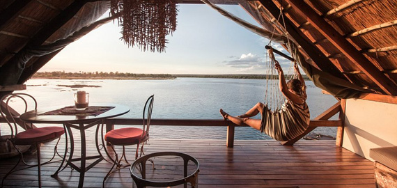 Woman on hammock looking onto river